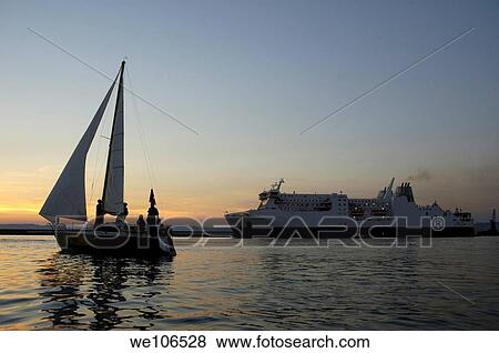Stock Photo - Sailboat and a ferry in the harbor, Marseille, France. Fotosearch