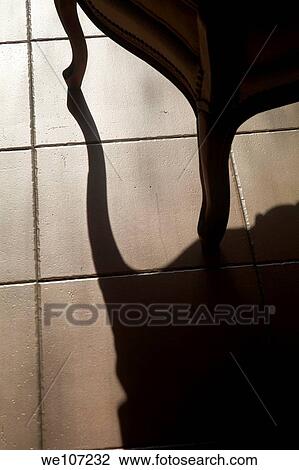 Shadow of an armchair on a tiled floor View Large Photo Image Stock Image - Shadow of an armchair on a tiled floor. Fotosearch