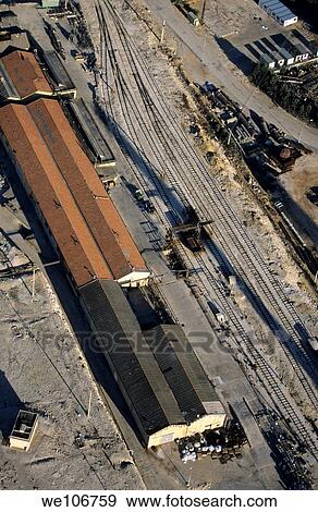 Sheds of an industrial site next to an abandoned railway View Large Photo Image Stock Photo - Sheds of an industrial site next to an abandoned railway. Fotosearch