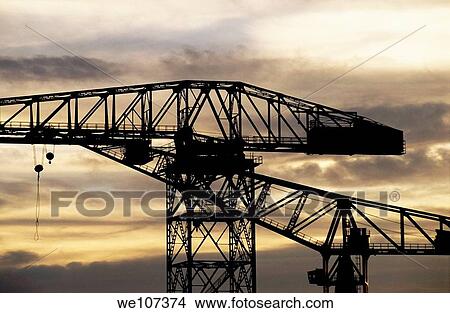 Silhouetted construction cranes at sunset View Large Photo Image Picture - Silhouetted construction cranes at sunset. Fotosearch
