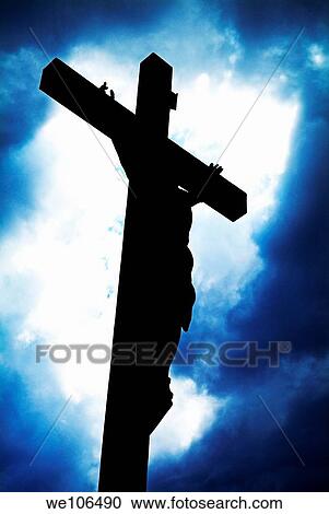 Stock Image - Silhouetted crucifix against a cloudy sky. Fotosearch