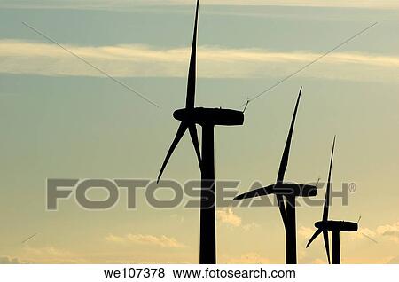 Stock Photo - Silhouetted wind turbines against a cloudy sky, Donzere, Drome, France. Fotosearch