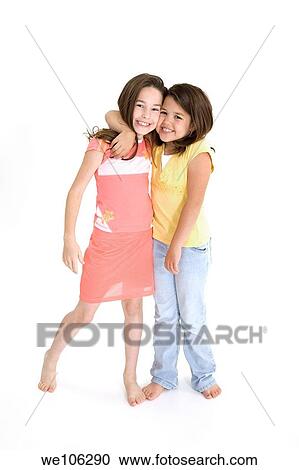 Sisters standing on white background smiling wearing casual clothes View Large Photo Image Stock Image - Sisters standing on white background smiling wearing casual clothes. Fotosearch