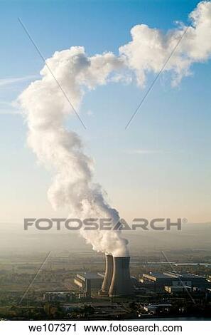 Stock Image - Smoke emitting from cooling towers of Tricastin Nuclear Power Plant, Rhone River Valley, Drome, France. Fotosearch