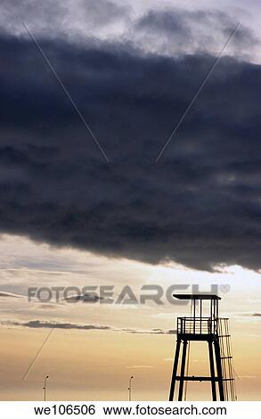 Storm clouds gathering over a lifeguard tower at sunset, Marseille, France View Large Photo Image Stock Photograph - Storm clouds gathering over a lifeguard tower at sunset, Marseille, France. Fotosearch