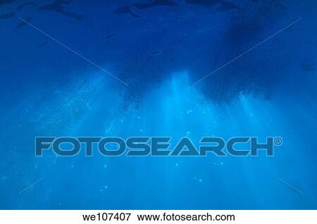 Stock Photo - Sunbeams penetrating the water´s surface. Fotosearch