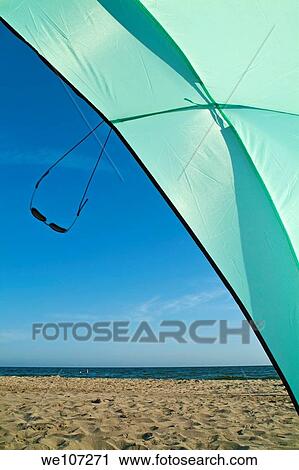 Sunglasses swinging from a sun shelter at the beach, Camargue, France View Large Photo Image Stock Image - Sunglasses swinging from a sun shelter at the beach, Camargue, France. Fotosearch