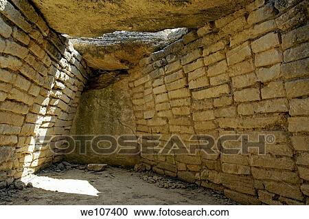 Stock Image - Sunlight in an ancient dolmen, Provence, France. Fotosearch