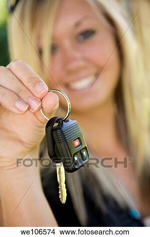 Teenage girl holding out the keys to her car View Large Photo Image Picture - Teenage girl holding out the keys to her car. Fotosearch