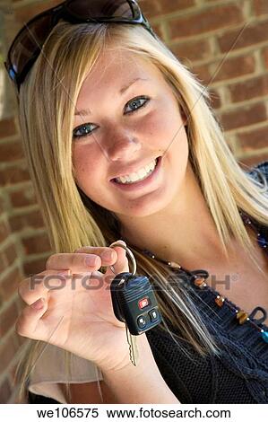 Teenage girl holding out the keys to her car View Large Photo Image Stock Photography - Teenage girl holding out the keys to her car. Fotosearch