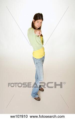 Teenage girl posing on a white background View Large Photo Image Stock Image - Teenage girl posing on a white background. Fotosearch