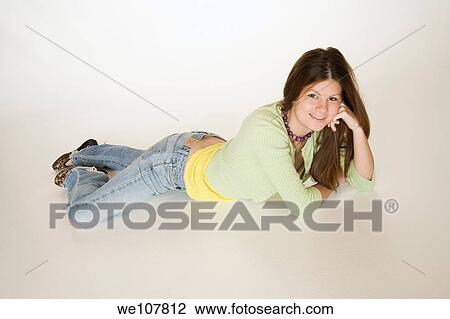 Teenage girl posing on a white background View Large Photo Image Stock Image - Teenage girl posing on a white background. Fotosearch