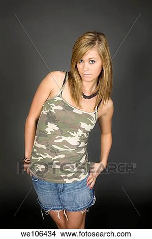 Teenage girl posing on gray background with some attitude View Large Photo Image Picture - Teenage girl posing on gray background with some attitude. Fotosearch
