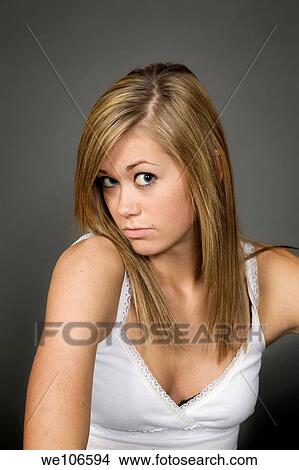 Teenage girl posing on gray background with some attitude View Large Photo Image Picture - Teenage girl posing on gray background with some attitude. Fotosearch