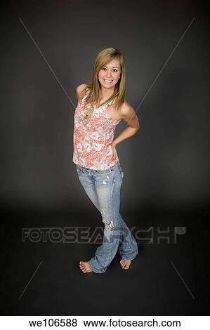 Teenage girl posing on gray background with some attitude View Large Photo Image Stock Photo - Teenage girl posing on gray background with some attitude. Fotosearch