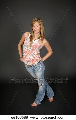 Stock Photo - Teenage girl posing on gray background with some attitude. Fotosearch