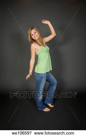 Teenage girl posing on gray background with some attitude View Large Photo Image Stock Photo - Teenage girl posing on gray background with some attitude. Fotosearch