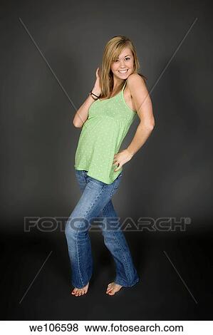 Teenage girl posing on gray background with some attitude View Large Photo Image Stock Photo - Teenage girl posing on gray background with some attitude. Fotosearch
