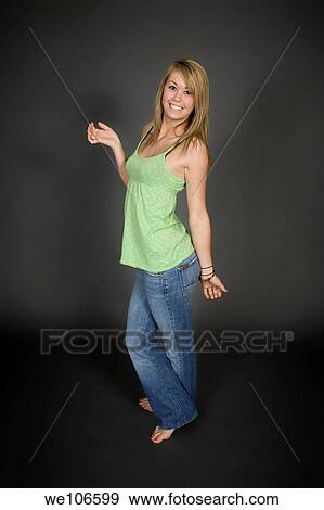 Teenage girl posing on gray background with some attitude View Large Photo Image Stock Photo - Teenage girl posing on gray background with some attitude. Fotosearch