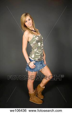 Teenage girl posing on gray background with some attitude View Large Photo Image Stock Photograph - Teenage girl posing on gray background with some attitude. Fotosearch