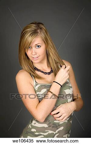 Teenage girl posing on gray background with some attitude View Large Photo Image Stock Photography - Teenage girl posing on gray background with some attitude. Fotosearch