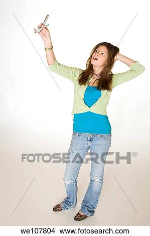 Teenage girl using a cell phone to take pictures View Large Photo Image Picture - Teenage girl using a cell phone to take pictures. Fotosearch