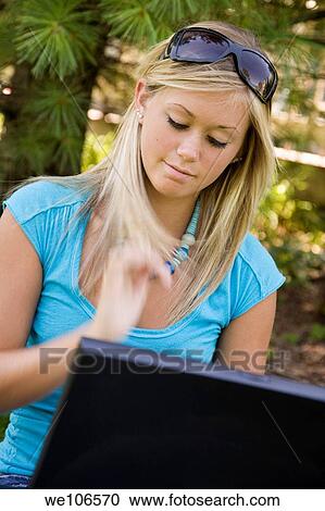 Teenage girl working on laptop computer outdoors View Large Photo Image Stock Image - Teenage girl working on laptop computer outdoors. Fotosearch