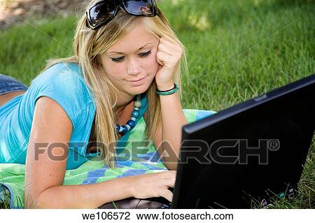 Teenage girl working on laptop computer outdoors View Large Photo Image Stock Image - Teenage girl working on laptop computer outdoors. Fotosearch