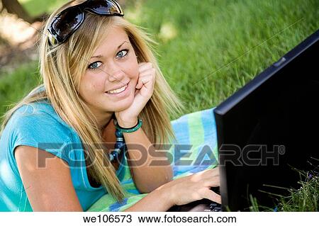 Teenage girl working on laptop computer outdoors View Large Photo Image Stock Image - Teenage girl working on laptop computer outdoors. Fotosearch