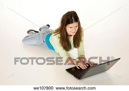 Teenage girl working on laptop computer View Large Photo Image Stock Image - Teenage girl working on laptop computer. Fotosearch