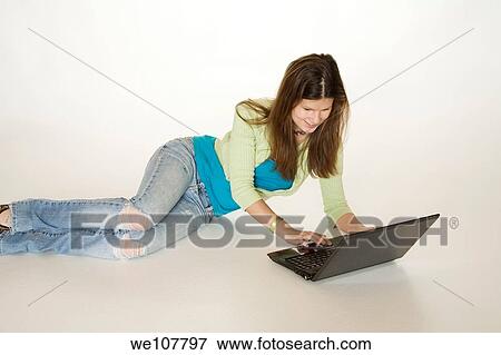 Teenage girl working on laptop computer View Large Photo Image Stock Photo - Teenage girl working on laptop computer. Fotosearch