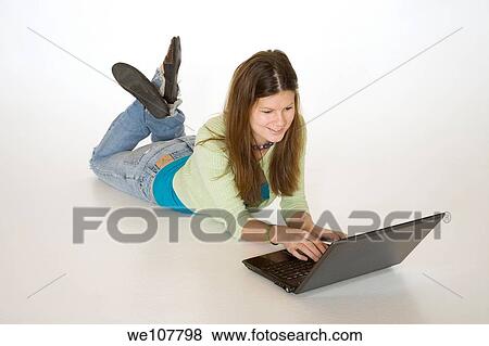 Teenage girl working on laptop computer View Large Photo Image Stock Photo - Teenage girl working on laptop computer. Fotosearch