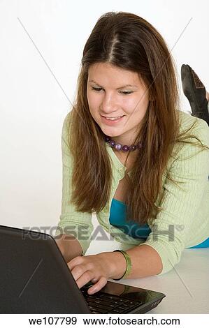 Teenage girl working on laptop computer View Large Photo Image Stock Photo - Teenage girl working on laptop computer. Fotosearch