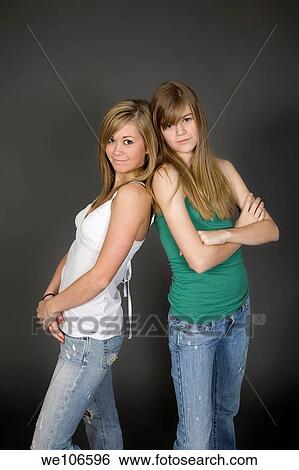 Teenage girls posing on gray background with some attitude View Large Photo Image Stock Photograph - Teenage girls posing on gray background with some attitude. Fotosearch