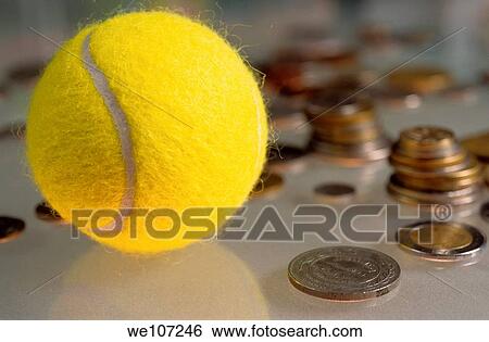 Tennis ball next to numerous piles of coins View Large Photo Image Stock Photograph - Tennis ball next to numerous piles of coins. Fotosearch