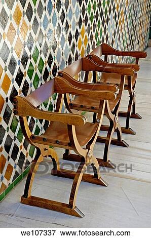 Three empty wooden seats in the Patio de los Arrayanes area of Alhambra, a 14th-century palace in Granada, Andalusia, Spain View Large Photo Image Stock Photo - Three empty wooden seats in the Patio de los Arrayanes area of Alhambra, a 14th-century palace in Granada, Andalusia, Spain. Fotosearch