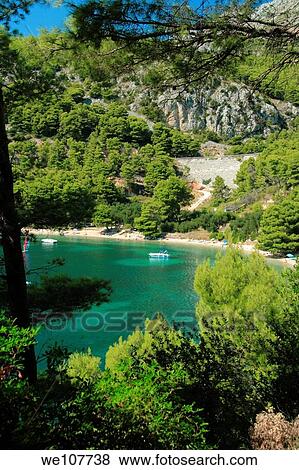 Tourists resting at a spectacular bay in Zivogosce village, Croatia View Large Photo Image Stock Photo - Tourists resting at a spectacular bay in Zivogosce village, Croatia. Fotosearch
