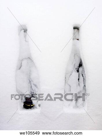 Two bottles of Champagne in the snow View Large Photo Image Stock Photo - Two bottles of Champagne in the snow. Fotosearch