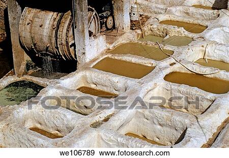 Stock Photo - Vats and wooden paddle wheel at a tannery, El Bali, Fez, Morocco. Fotosearch