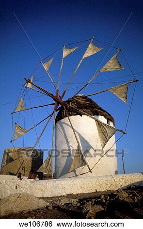 Stock Photograph - White windmill at sunset, Myconos, Greece. Fotosearch