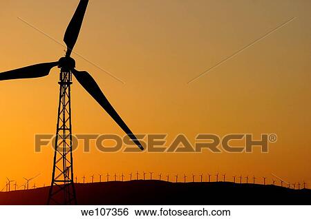 Stock Photograph - Wind turbine on a ridge at sunset, Tarifa, Andalusia, Spain. Fotosearch
