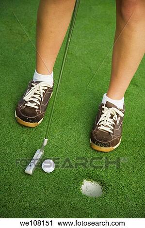Woman in her mid 20s playing golf View Large Photo Image Stock Image - Woman in her mid 20s playing golf. Fotosearch