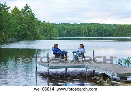 Woman Relaxing on Adirondack Chairs on Dock New Hampshire, USA MR RF 01-08 and RF 09-15 NO PR View Large Photo Image Picture - Woman Relaxing on Adirondack Chairs on Dock New Hampshire, USA MR RF 01-08 and RF 09-15 NO PR. Fotosearch