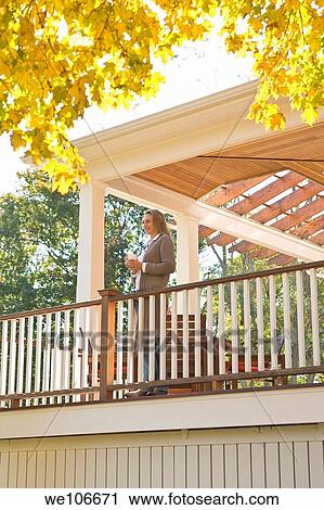 Woman with Coffee On Porch View Large Photo Image Stock Image - Woman with Coffee On Porch. Fotosearch