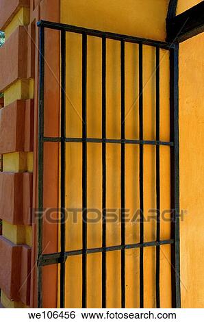Wrought iron gate against a yellow wall in the grounds of the Alcazar of Seville, Seville, Andalusia, Spain View Large Photo Image Stock Photograph - Wrought iron gate against a yellow wall in the grounds of the Alcazar of Seville, Seville, Andalusia, Spain. Fotosearch