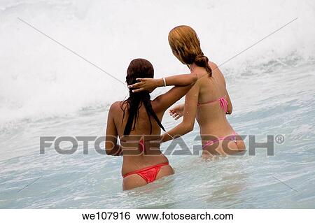 Young Brazilian girls playing in the surf on Copacabana Beach in Rio de Janeiro in Brazil View Large Photo Image Stock Photograph - Young Brazilian girls playing in the surf on Copacabana Beach in Rio de Janeiro in Brazil. Fotosearch