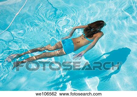 Young girl swimming under water View Large Photo Image Stock Image - Young girl swimming under water. Fotosearch