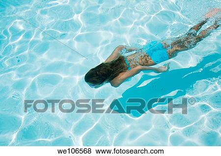 Young girl swimming under water View Large Photo Image Stock Photo - Young girl swimming under water. Fotosearch