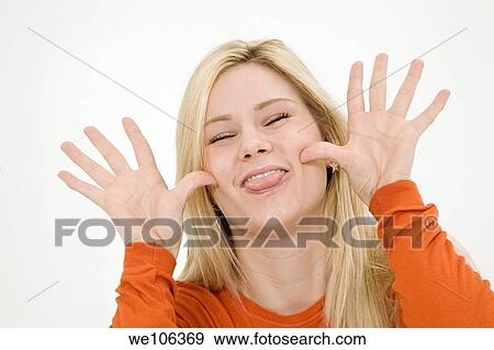 Young woman posing on a white background acting silly View Large Photo Image Stock Photo - Young woman posing on a white background acting silly. Fotosearch