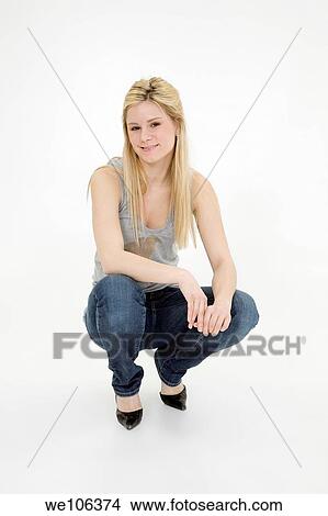 Picture - Young woman posing on white background with some attitude. Fotosearch